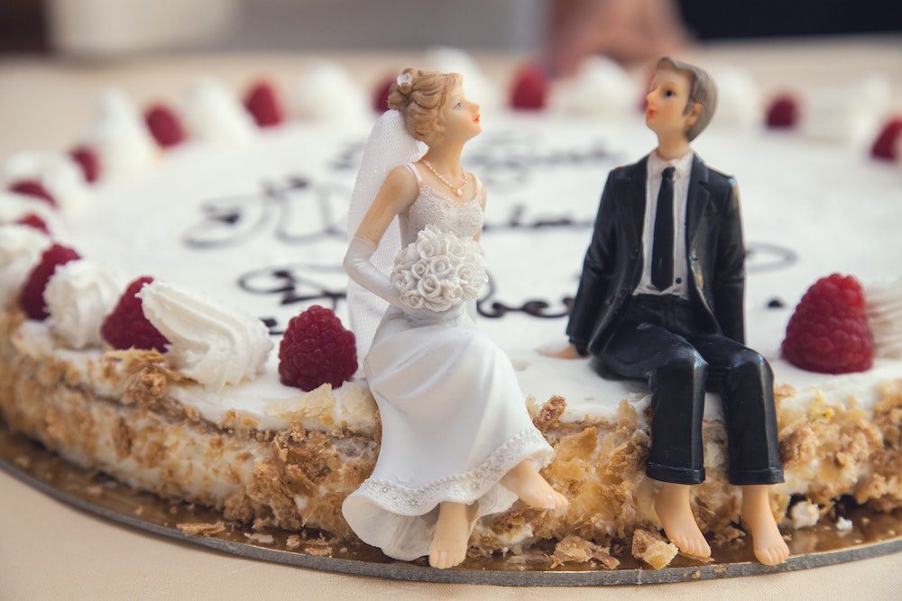 close up of small people on a wedding cake
