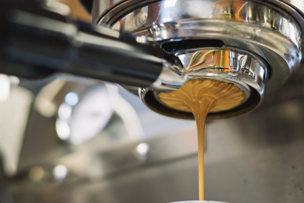 Espresso liquid pouring out of an espresso machine