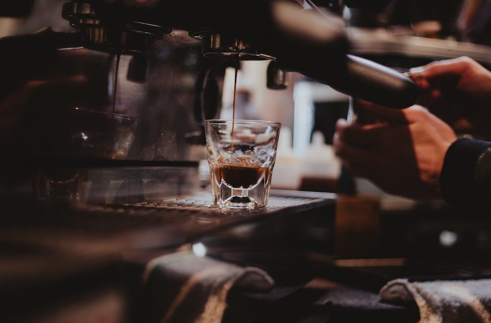 A coffee machine pouring an espresso