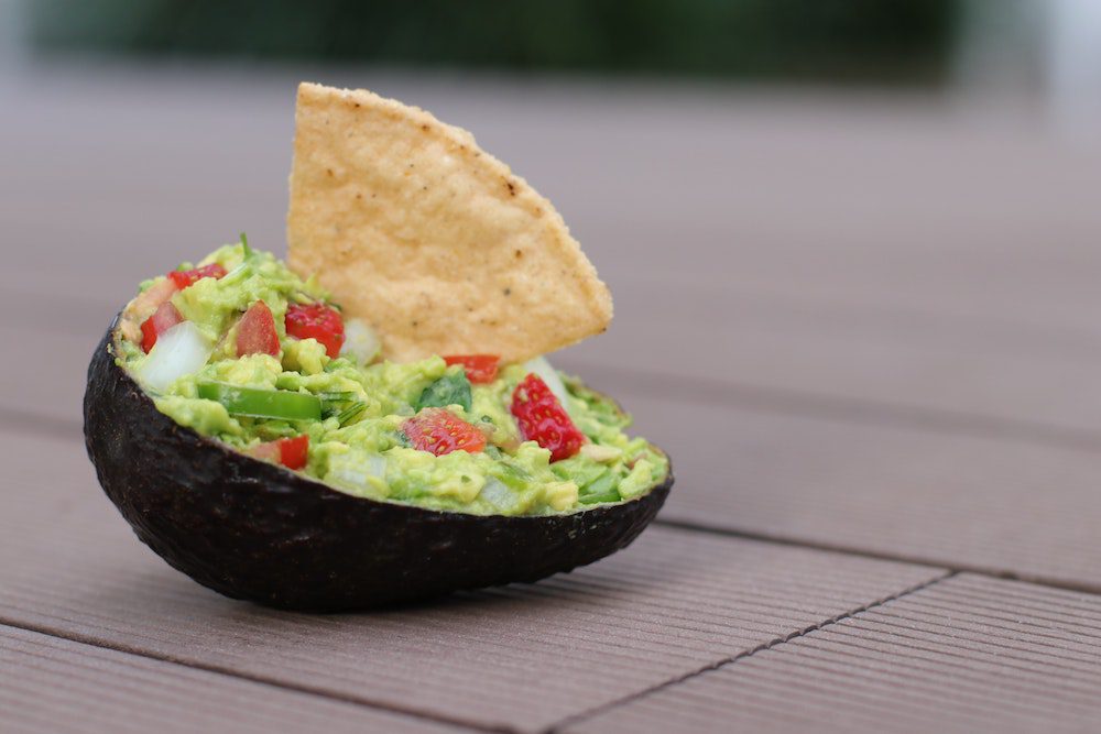 avocado shell filled with guacamole and a crisp 