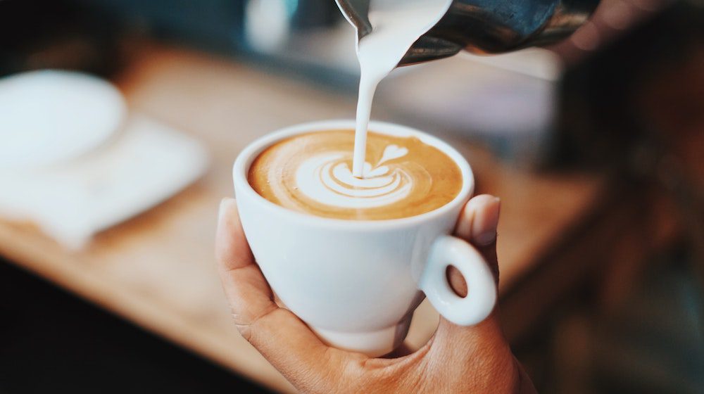 Milk being poured into a latte