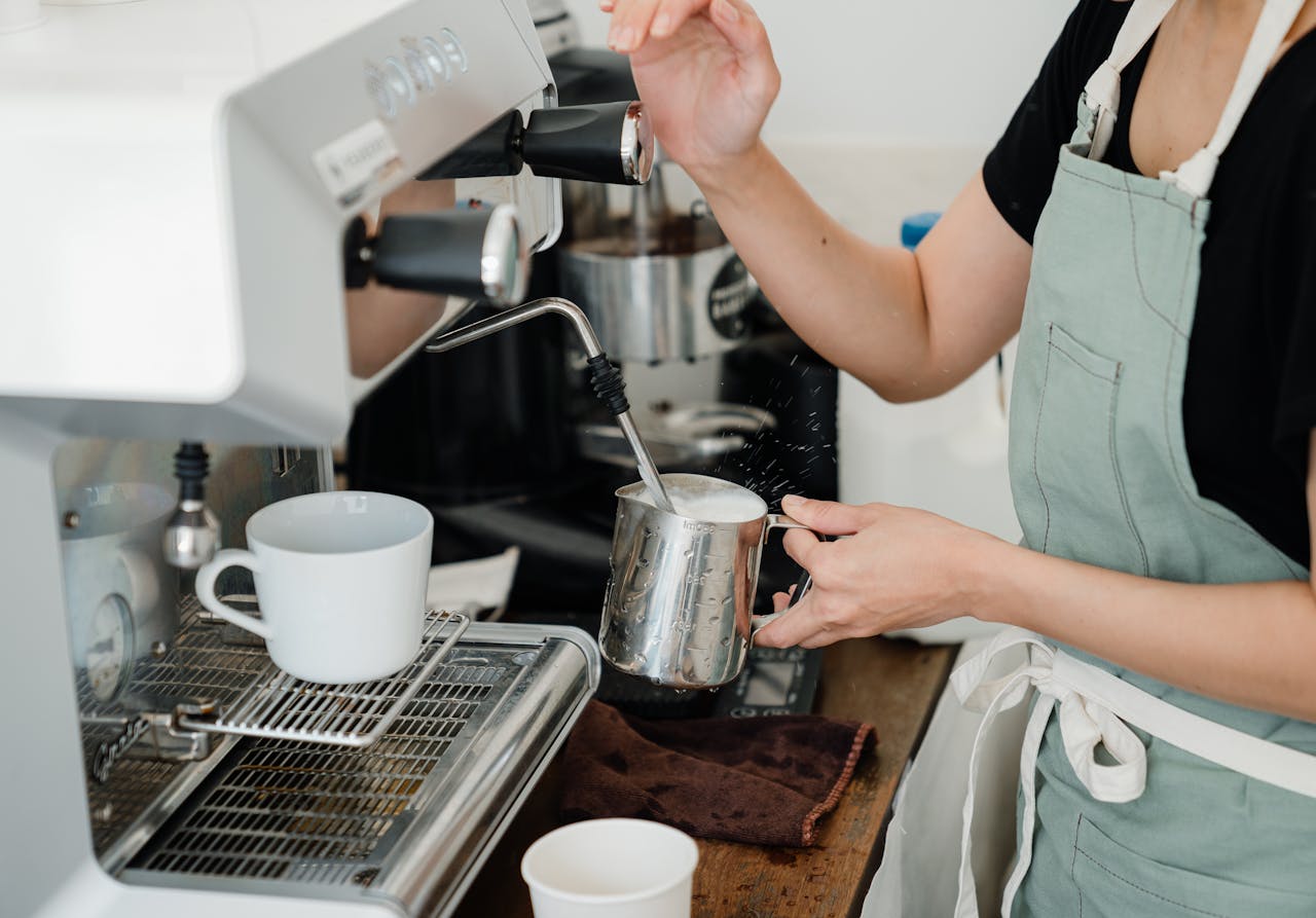 A barista making foamed milk