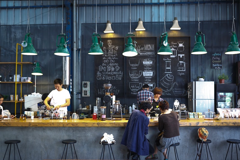 A coffee shop with green pendant lights