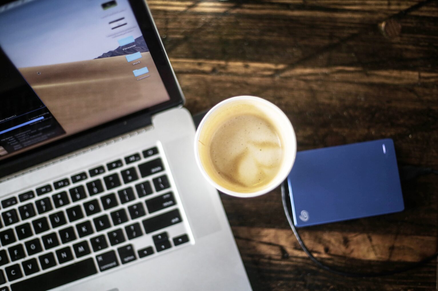 A coffee next to a laptop
