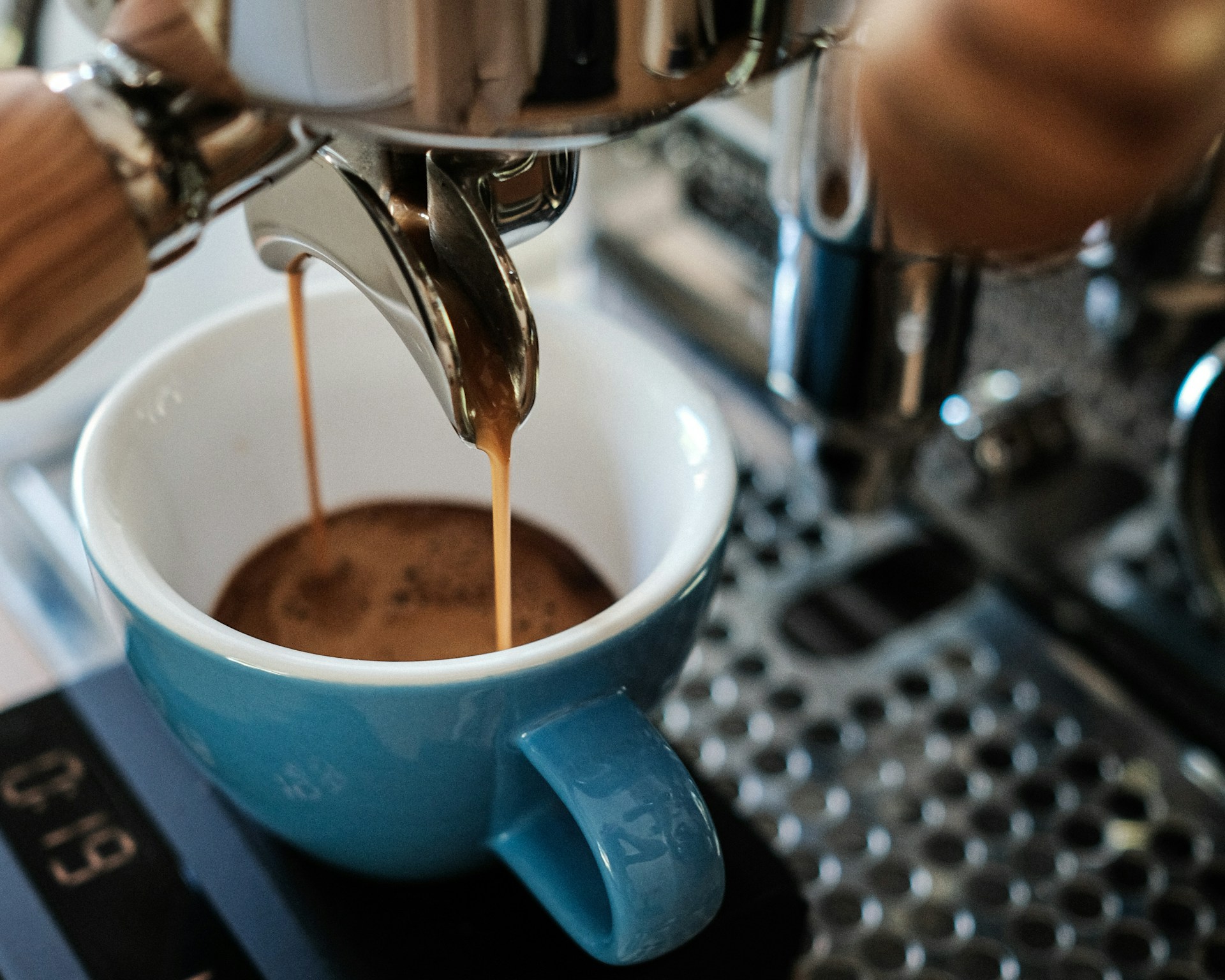 An espresso pouring into a coffee machine