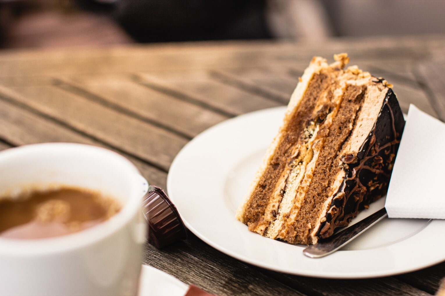 A slice of cake with a cup of coffee