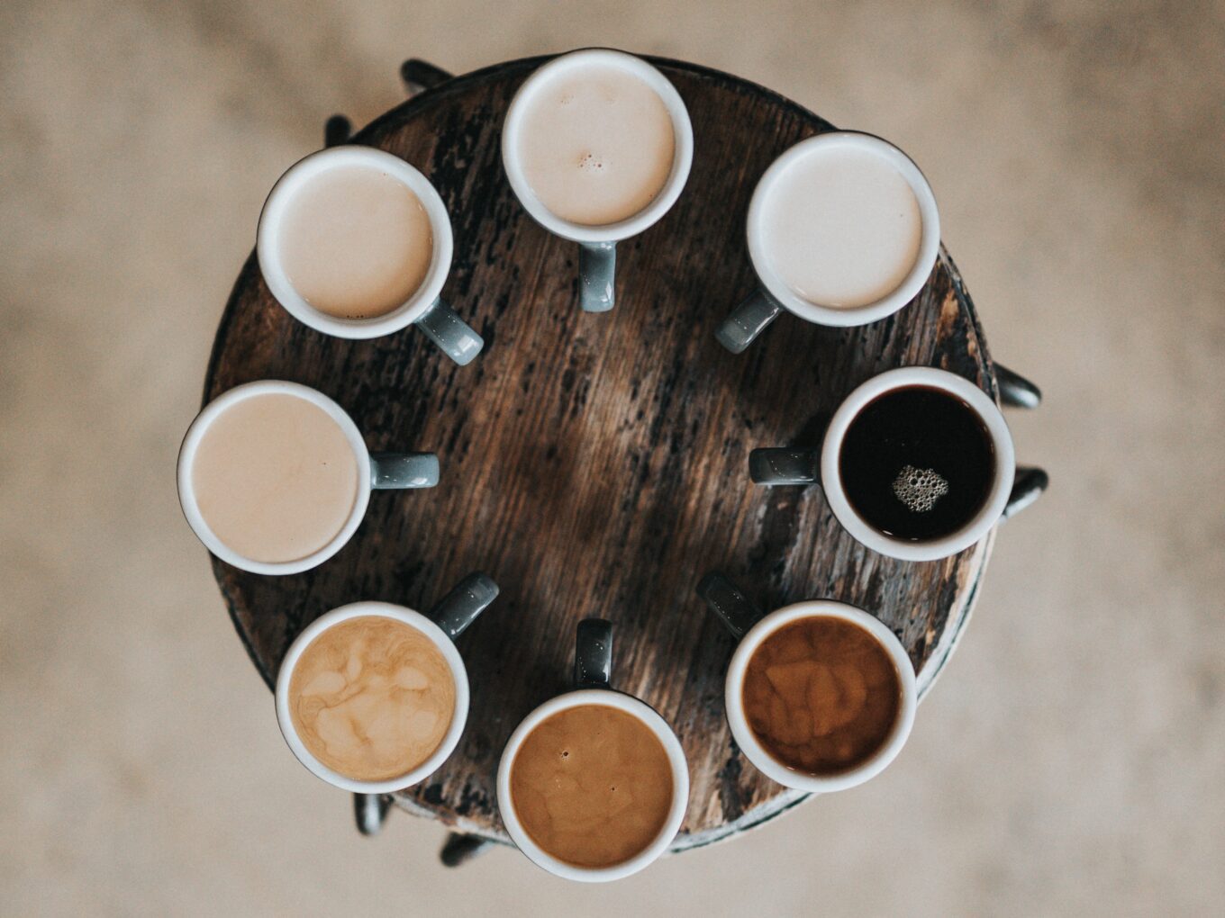 a circle of coffee cups, all with a different type of coffee in
