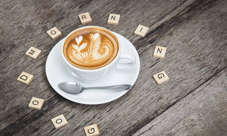 Coffee cup with Scrabble tiles spelling good morning 