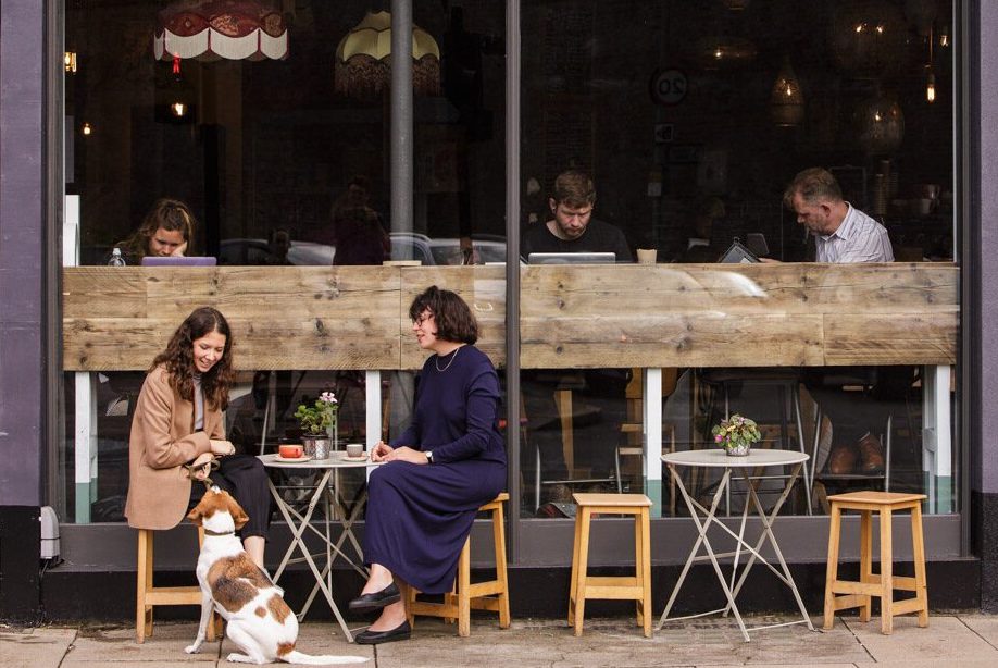 Two people sat outside an Esquires store
