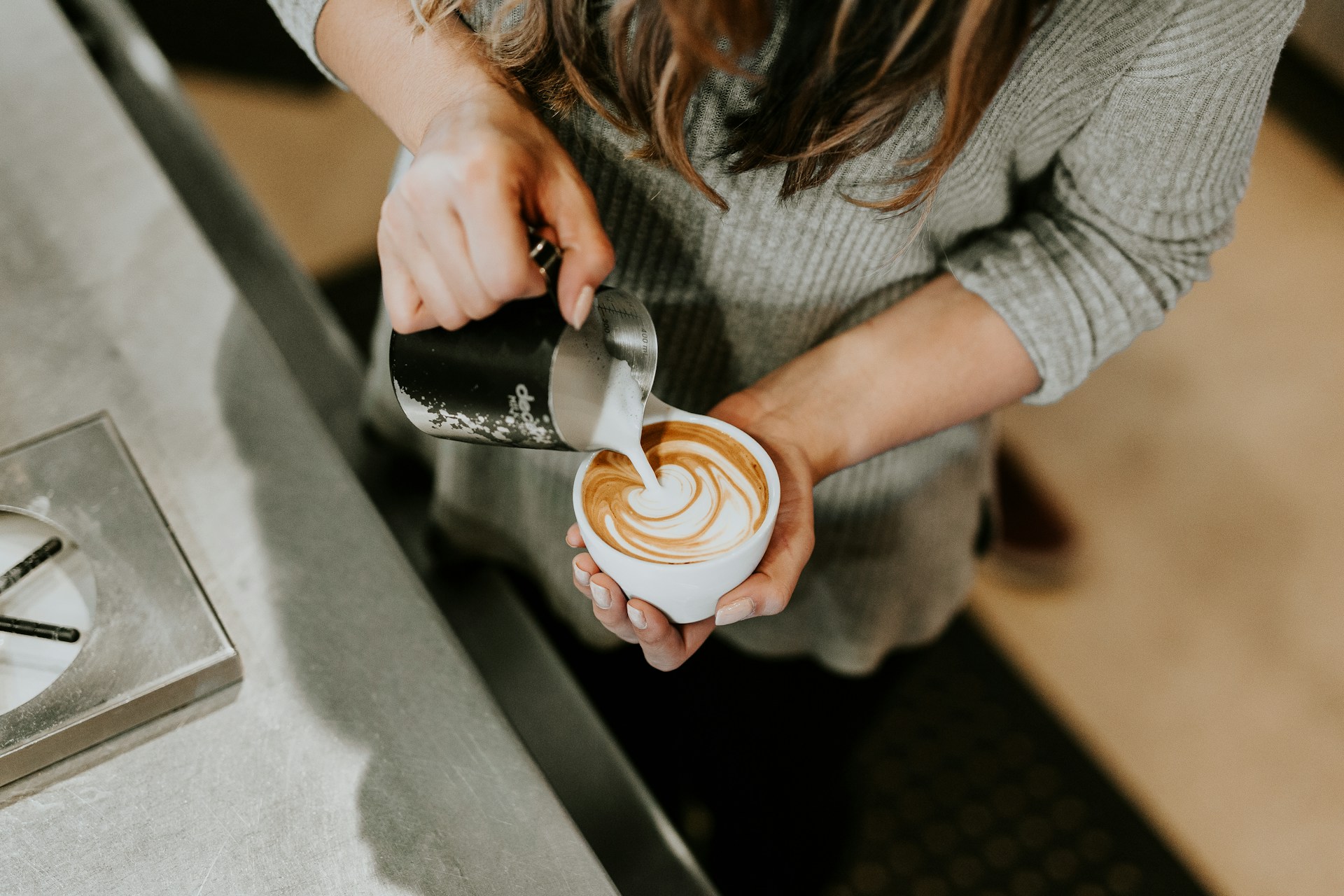 Barista pouring coffee