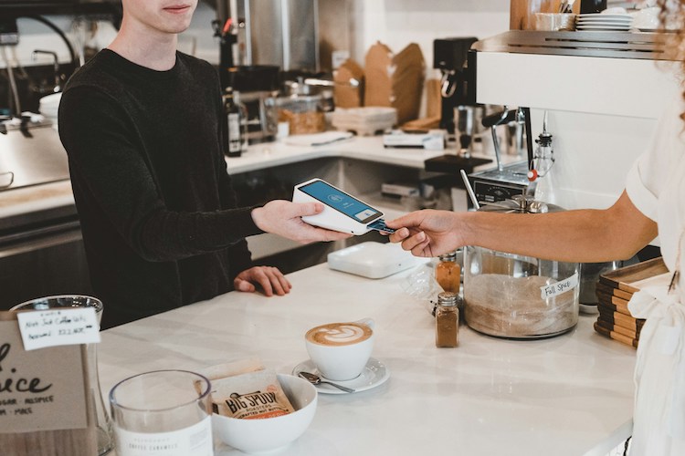 Someone paying for coffee in a coffee shop