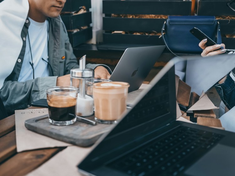 People meeting with laptops and coffee