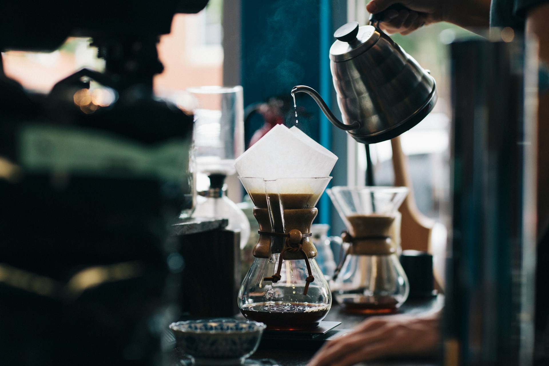 Barista pouring drip coffee