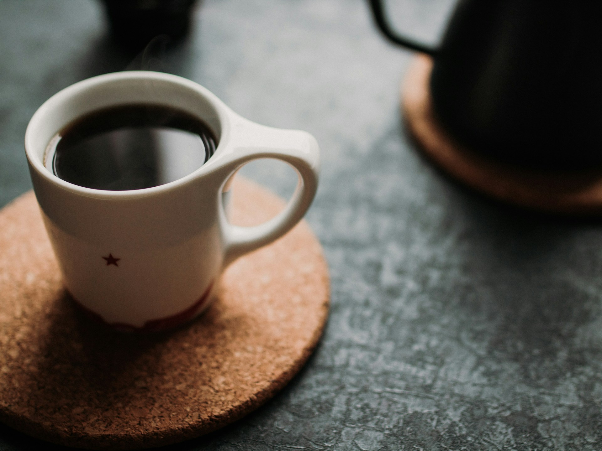 A small white cup of black coffee