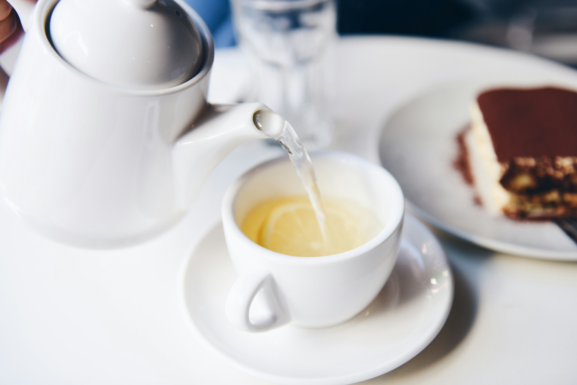 Tea pouring into white tea cup