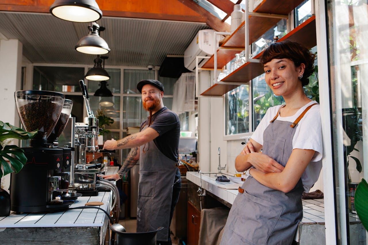 Two baristas behind a counter