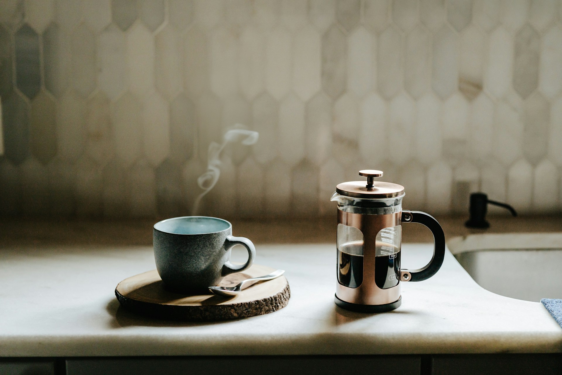 Blue streaming mug next to half-full French press 